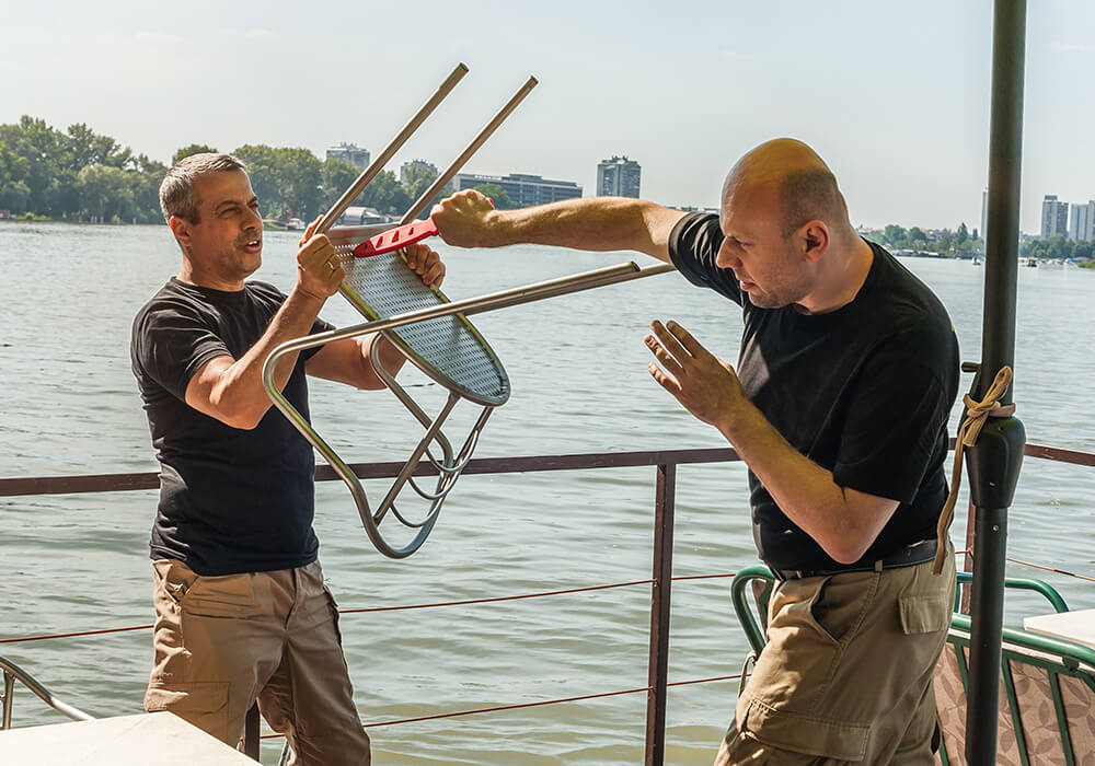 Krav Maga self-defense demonstration using a chair