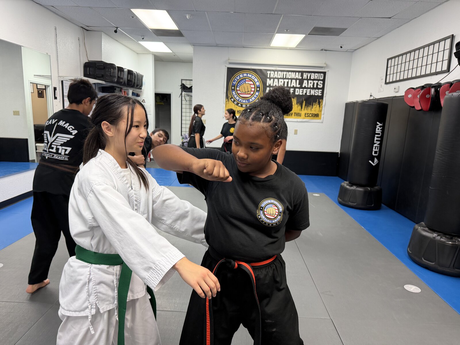 Two Junior Warriors students practicing a technique together